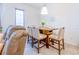 Cozy dining area with a wooden table, chairs, and modern lighting fixture at 665 Longboat Dr, Davenport, FL 33896