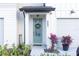 Inviting front entrance with a light green door and a welcoming wreath at 665 Longboat Dr, Davenport, FL 33896
