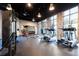 Bright gym features high ceilings, exposed brick, and plenty of exercise equipment at 665 Longboat Dr, Davenport, FL 33896