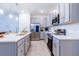 Beautiful kitchen with grey cabinets, quartz countertops, and stainless steel appliances at 665 Longboat Dr, Davenport, FL 33896