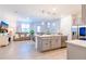 Open-concept living area featuring an island with seating and stainless steel appliances at 665 Longboat Dr, Davenport, FL 33896