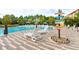 Relax by the large pool with ample lounge chairs and scenic landscaping at 665 Longboat Dr, Davenport, FL 33896