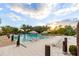Relaxing pool area with plenty of lounge chairs and umbrellas, surrounded by beautiful landscaping and palm trees at 665 Longboat Dr, Davenport, FL 33896