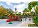 A pirate themed splash pad includes a slide and water features surrounded by tropical landscaping at 665 Longboat Dr, Davenport, FL 33896
