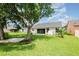 Spacious backyard with mature trees and a well-maintained lawn, offering a serene outdoor space at 685 Middlebury Loop, New Smyrna Beach, FL 32168