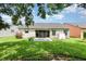 This backyard features a well-maintained lawn, a patio, mature landscaping, and a partial privacy fence at 685 Middlebury Loop, New Smyrna Beach, FL 32168
