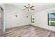 Serene bedroom with wood-look floors, featuring shiplap accent wall and abundant natural light at 685 Middlebury Loop, New Smyrna Beach, FL 32168