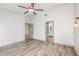 Bright bedroom boasts wood-look floors, modern fan and access to ensuite bathroom at 685 Middlebury Loop, New Smyrna Beach, FL 32168