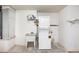 This laundry room features a stacked washer and dryer, a utility sink, and room for storage at 685 Middlebury Loop, New Smyrna Beach, FL 32168
