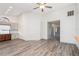 Bright open-plan living room with wood-look floors and accent wall at 685 Middlebury Loop, New Smyrna Beach, FL 32168