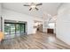 Bright living space with wood-look floors, opening to the kitchen and a screened patio with lake views at 685 Middlebury Loop, New Smyrna Beach, FL 32168