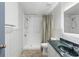 Bathroom featuring a walk-in shower, vanity with a gray marble top and mirror, providing a functional design at 6906 Sawmill Blvd, Ocoee, FL 34761
