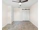 Neutral bedroom with natural light, a sliding-door closet, and elegant tile flooring, creating a peaceful ambiance at 6906 Sawmill Blvd, Ocoee, FL 34761