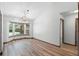 Bright dining room features wood flooring, a bay window, and updated light fixtures at 6906 Sawmill Blvd, Ocoee, FL 34761