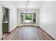 Bright dining area with hardwood floors, bay window, and modern lighting fixture at 6906 Sawmill Blvd, Ocoee, FL 34761