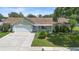 Charming one-story home with well-maintained lawn and landscaping on a bright sunny day at 6906 Sawmill Blvd, Ocoee, FL 34761