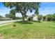 Picture of home's front lawn with mature tree at 6906 Sawmill Blvd, Ocoee, FL 34761