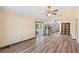 Open concept living room with wood flooring that leads to a kitchen and french doors at 6906 Sawmill Blvd, Ocoee, FL 34761