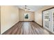Bright living room with wood flooring, double glass paneled doors and large windows at 6906 Sawmill Blvd, Ocoee, FL 34761