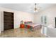 Bedroom featuring unique flooring, ceiling fan and access to a private pool area at 6906 Sawmill Blvd, Ocoee, FL 34761