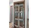 Unique wine cellar with weathered door, secure metal bars, and rustic wooden shelves providing secure bottle storage at 6906 Sawmill Blvd, Ocoee, FL 34761