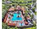 Aerial view showcasing the community pool, lounge areas, and lush landscaping at 8020 Tuscany Way # 6307, Davenport, FL 33896