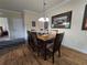 Dining room with wood table and chairs, hardwood floors and decorative wall art at 8020 Tuscany Way # 6307, Davenport, FL 33896