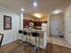 Open kitchen featuring a breakfast bar, wood cabinets and modern appliances at 8020 Tuscany Way # 6307, Davenport, FL 33896