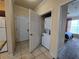 Hallway laundry area with tile floors and a stacked washer and dryer at 8020 Tuscany Way # 6307, Davenport, FL 33896