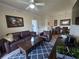 Open concept living room with ceiling fan, hardwood floors and neutral colors at 8020 Tuscany Way # 6307, Davenport, FL 33896