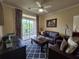 Cozy living room with a ceiling fan and a view of the patio at 8020 Tuscany Way # 6307, Davenport, FL 33896