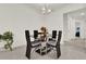 Contemporary dining room features a glass table and modern black chairs with gray cushions at 804 Glen Creek Ct, Fruitland Park, FL 34731