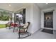 Inviting front porch featuring rocking chairs and a porch swing, perfect for relaxation and enjoying the outdoors at 804 Glen Creek Ct, Fruitland Park, FL 34731