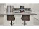 Kitchen island featuring granite countertop, barstool seating, and stainless steel appliances at 804 Glen Creek Ct, Fruitland Park, FL 34731