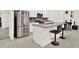 Kitchen island featuring granite countertop, barstool seating, and stainless steel appliances at 804 Glen Creek Ct, Fruitland Park, FL 34731