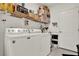 Laundry room with white washer and dryer, wire shelving, and ample storage space at 804 Glen Creek Ct, Fruitland Park, FL 34731