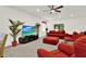 Bright, open living room with modern furnishings, ceiling fan, and large TV for enjoyable relaxation and entertainment at 804 Glen Creek Ct, Fruitland Park, FL 34731