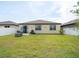 A backyard with a patio, green grass, and privacy fence at 8710 Rindge Rd, Polk City, FL 33868