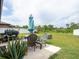 Patio area with green lawn and a view of the wooded area at 8710 Rindge Rd, Polk City, FL 33868