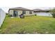A spacious backyard with a patio area, green grass, and a privacy fence at 8710 Rindge Rd, Polk City, FL 33868