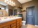 Bathroom with a wood vanity with double sinks, floating shelves, and a glass enclosed shower at 8710 Rindge Rd, Polk City, FL 33868