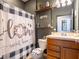 Cozy bathroom with a decorative shower curtain and a lovely vanity sink at 8710 Rindge Rd, Polk City, FL 33868