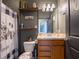 Cozy bathroom with decorative shower curtain and floating wood shelves at 8710 Rindge Rd, Polk City, FL 33868