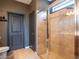Bathroom featuring a tiled shower with glass enclosure, tiled floors and neutral paint at 8710 Rindge Rd, Polk City, FL 33868