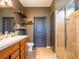 Neutral toned bathroom featuring a double vanity, decorative shelving, and tiled walk-in shower at 8710 Rindge Rd, Polk City, FL 33868