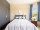 Cozy bedroom with large window, neutral color scheme, and comfortable decor elements at 8710 Rindge Rd, Polk City, FL 33868