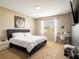 Bright bedroom with carpeted floors, vanity area, and a large window at 8710 Rindge Rd, Polk City, FL 33868