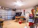 Finished garage space featuring painted flooring, overhead storage, and decorated back wall at 8710 Rindge Rd, Polk City, FL 33868