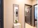 Hallway with mirrors, décor, and neutral colors that leads into other rooms in the home at 8710 Rindge Rd, Polk City, FL 33868