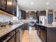 Well-equipped kitchen featuring stainless steel appliances, granite counters, subway tile backsplash, and island at 8710 Rindge Rd, Polk City, FL 33868